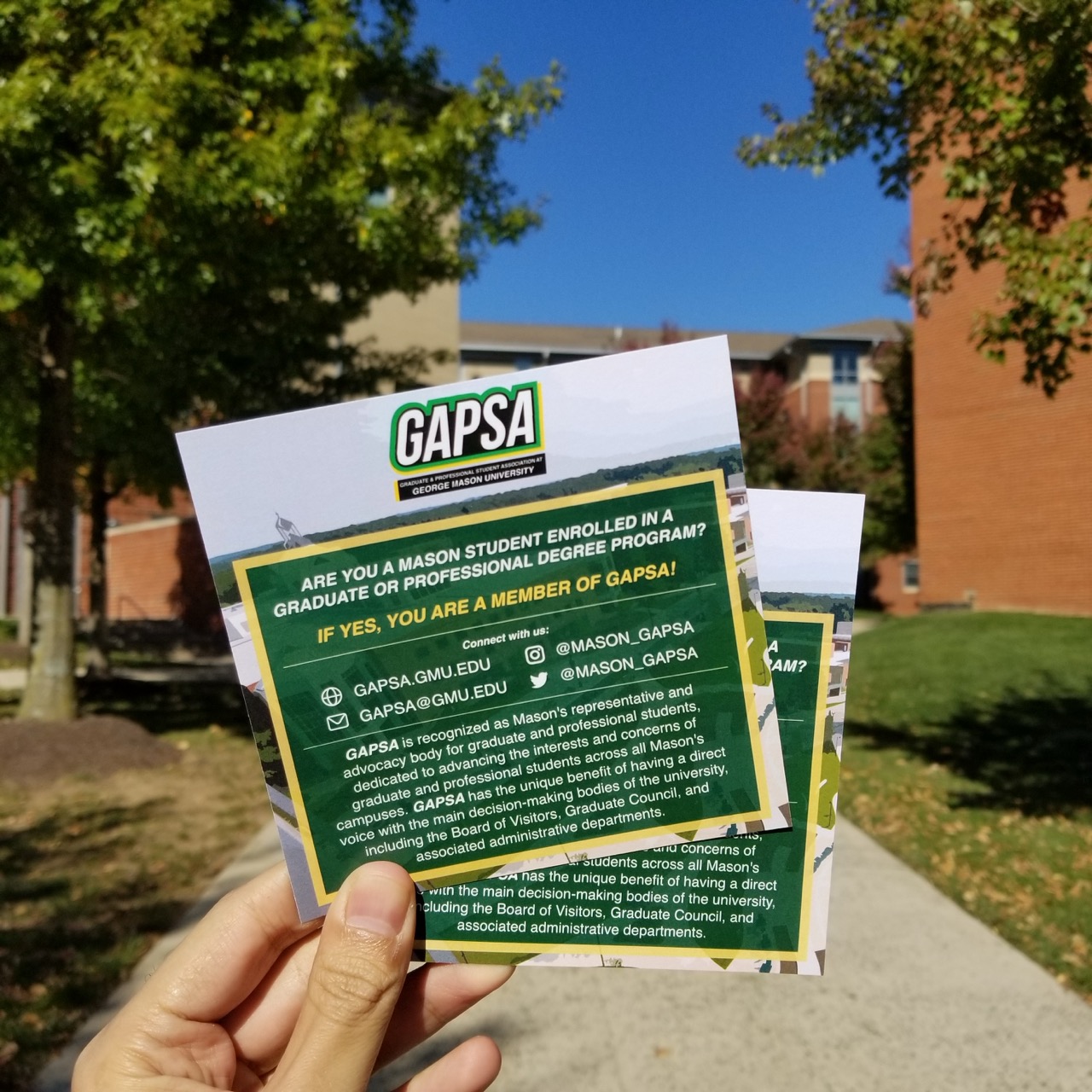 Two brochures in a hand.